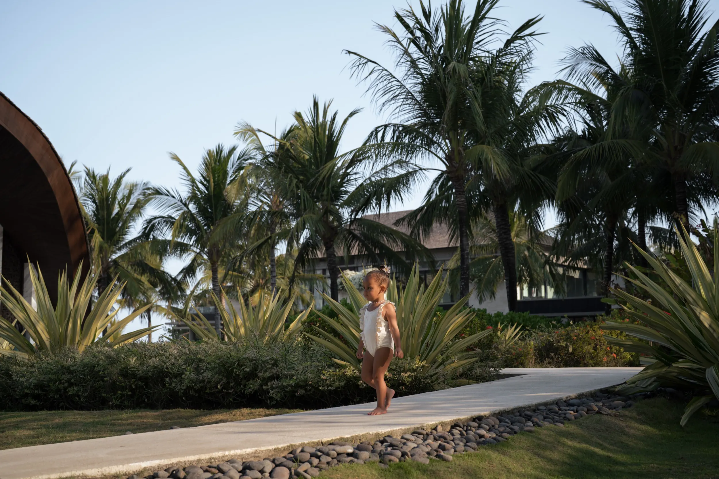 Editorial lifestyle: Risa Mia walking a garden pathway at golden hour