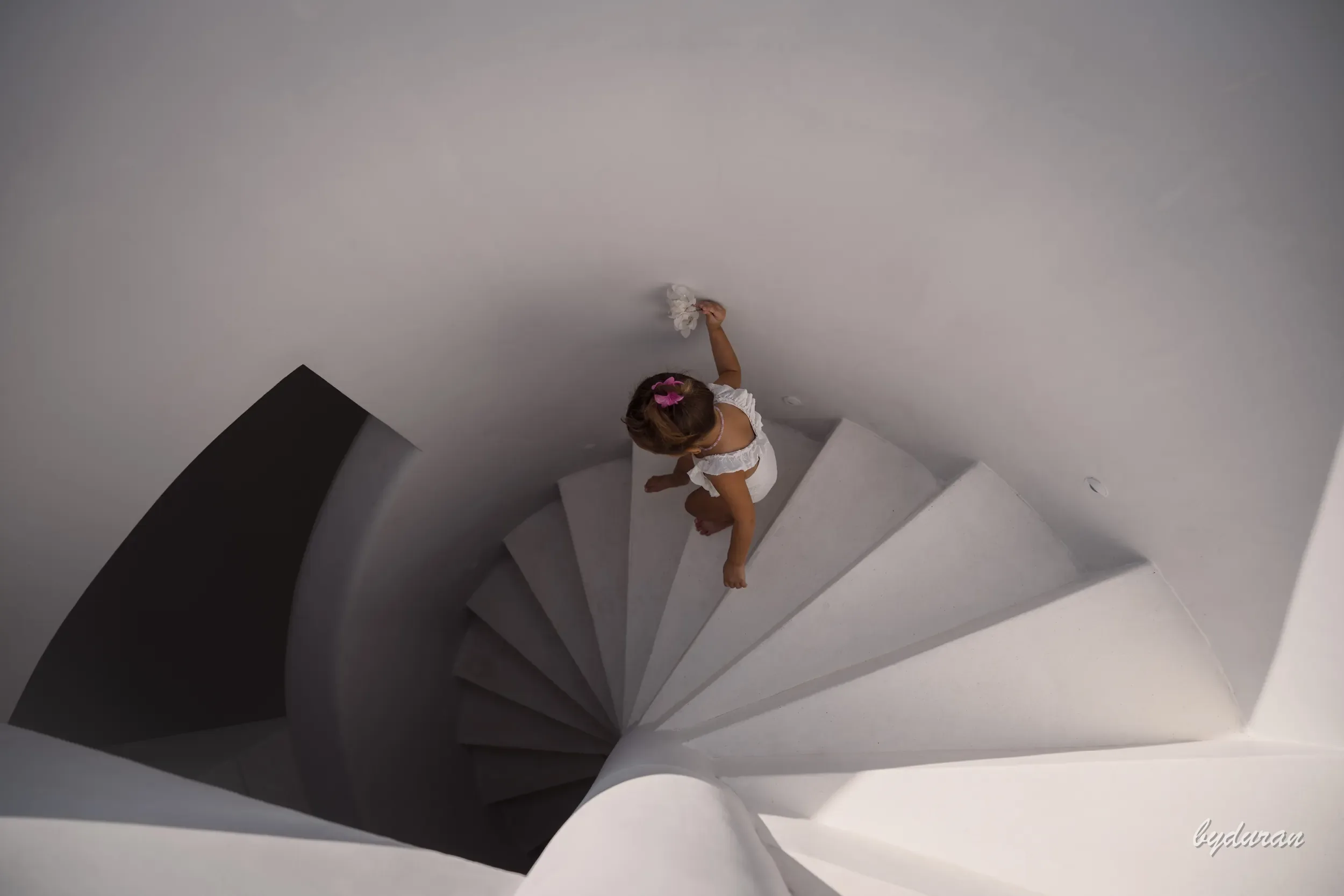 Wide aerial — Risa Mia on the villa's spiral staircase