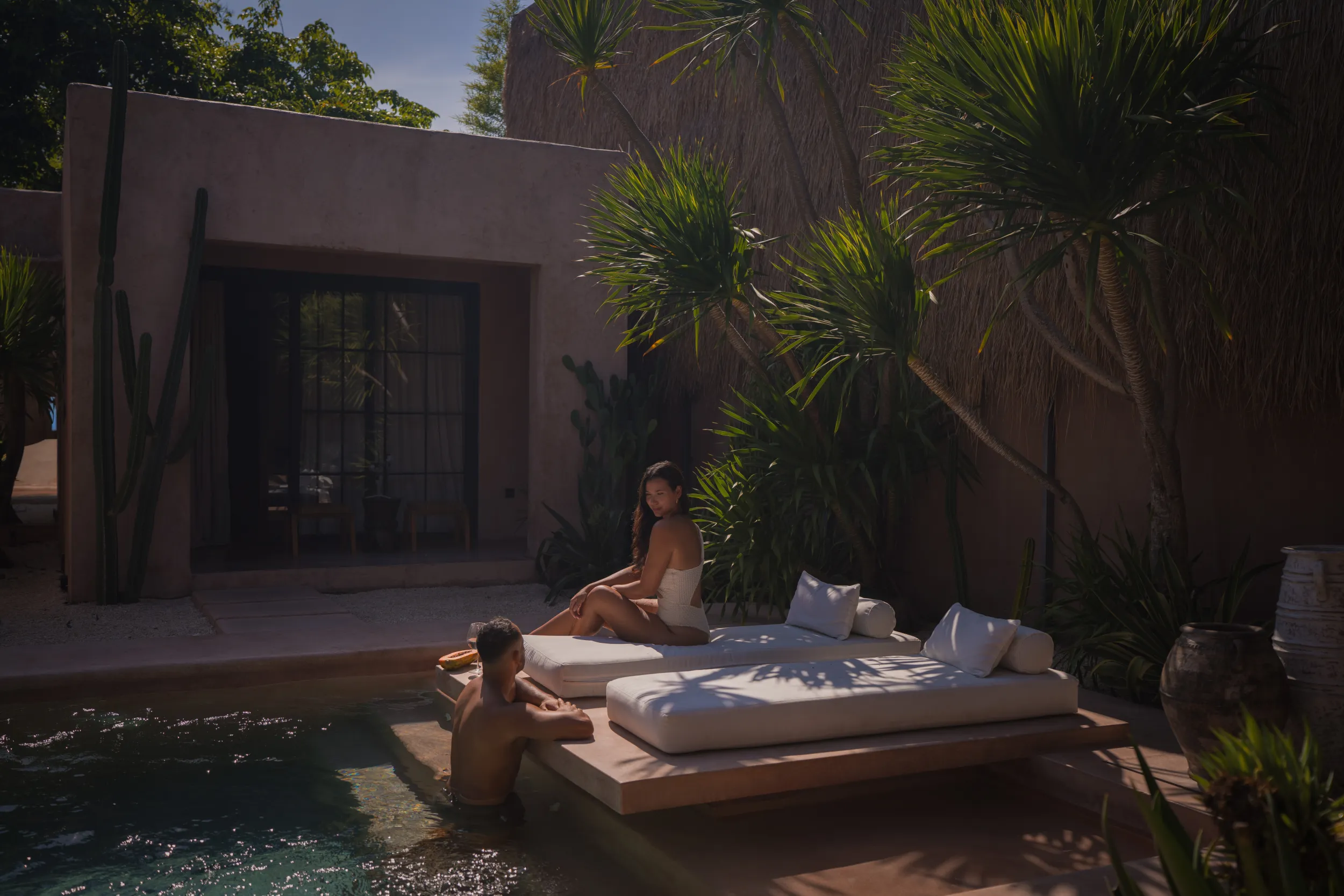 Editorial lifestyle: couple at the poolside daybed
