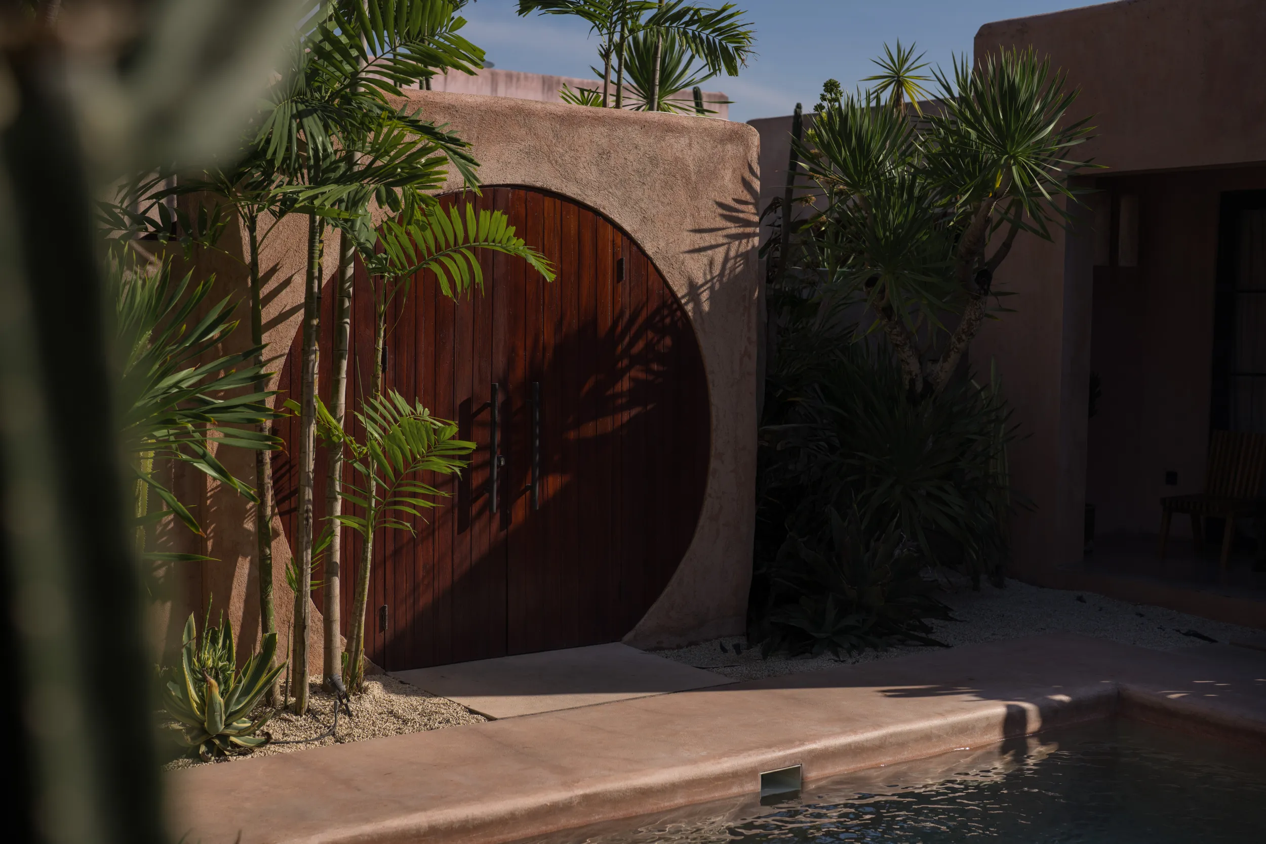 Spaces and architecture: circular wooden door, poolside