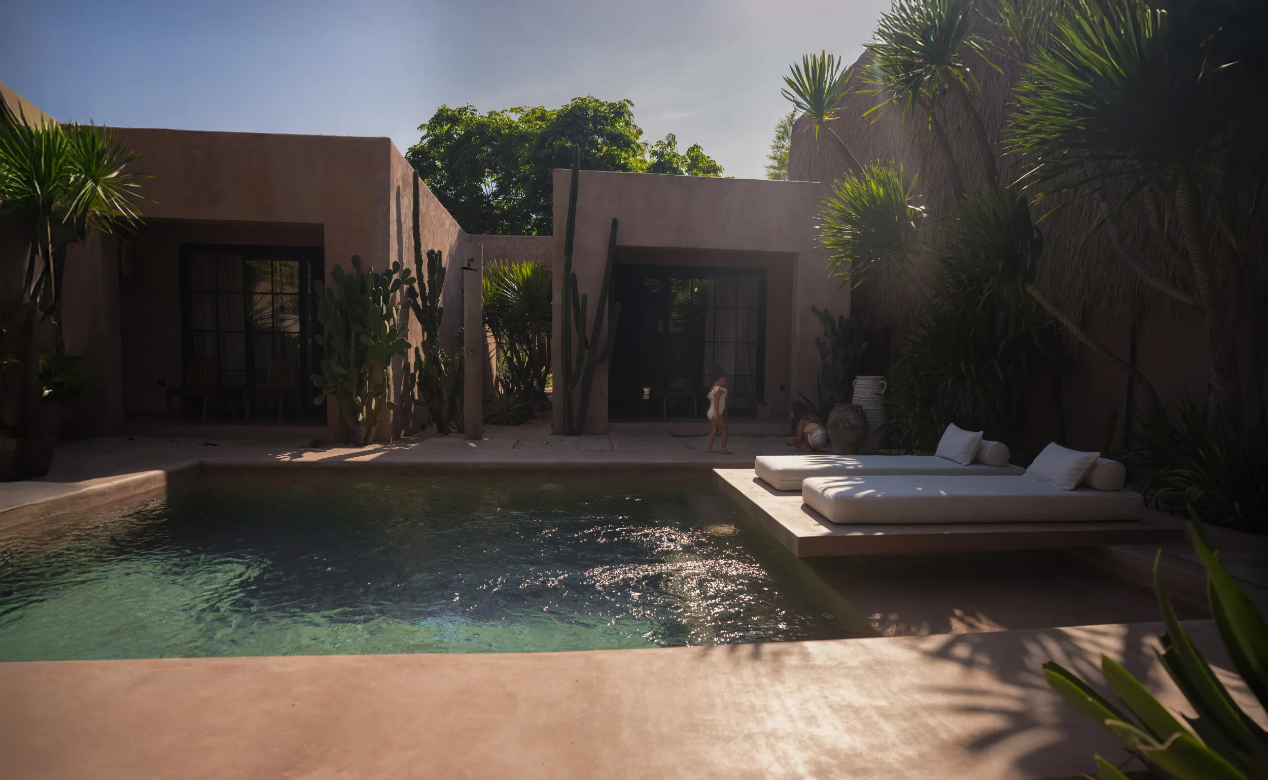 Editorial lifestyle: villa courtyard pool at golden hour